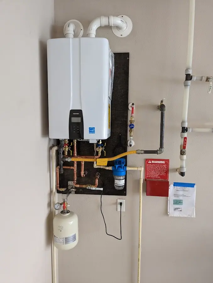 Professional plumber installing copper piping in a Lula home